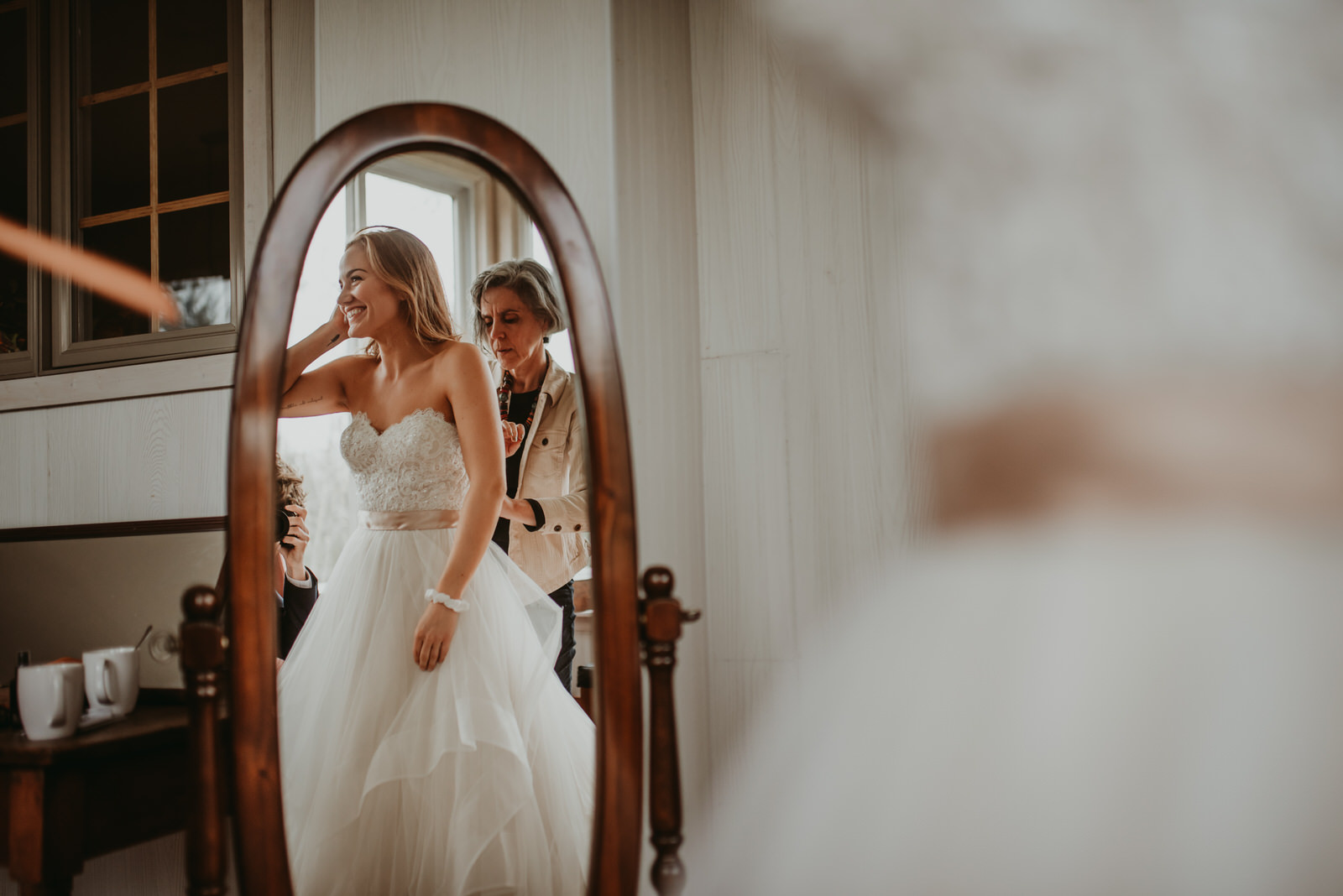 bride getting ready in front of a mirror, the cutest BHLDN dress, moody photography, Chicago wedding photography - The Adamkovi