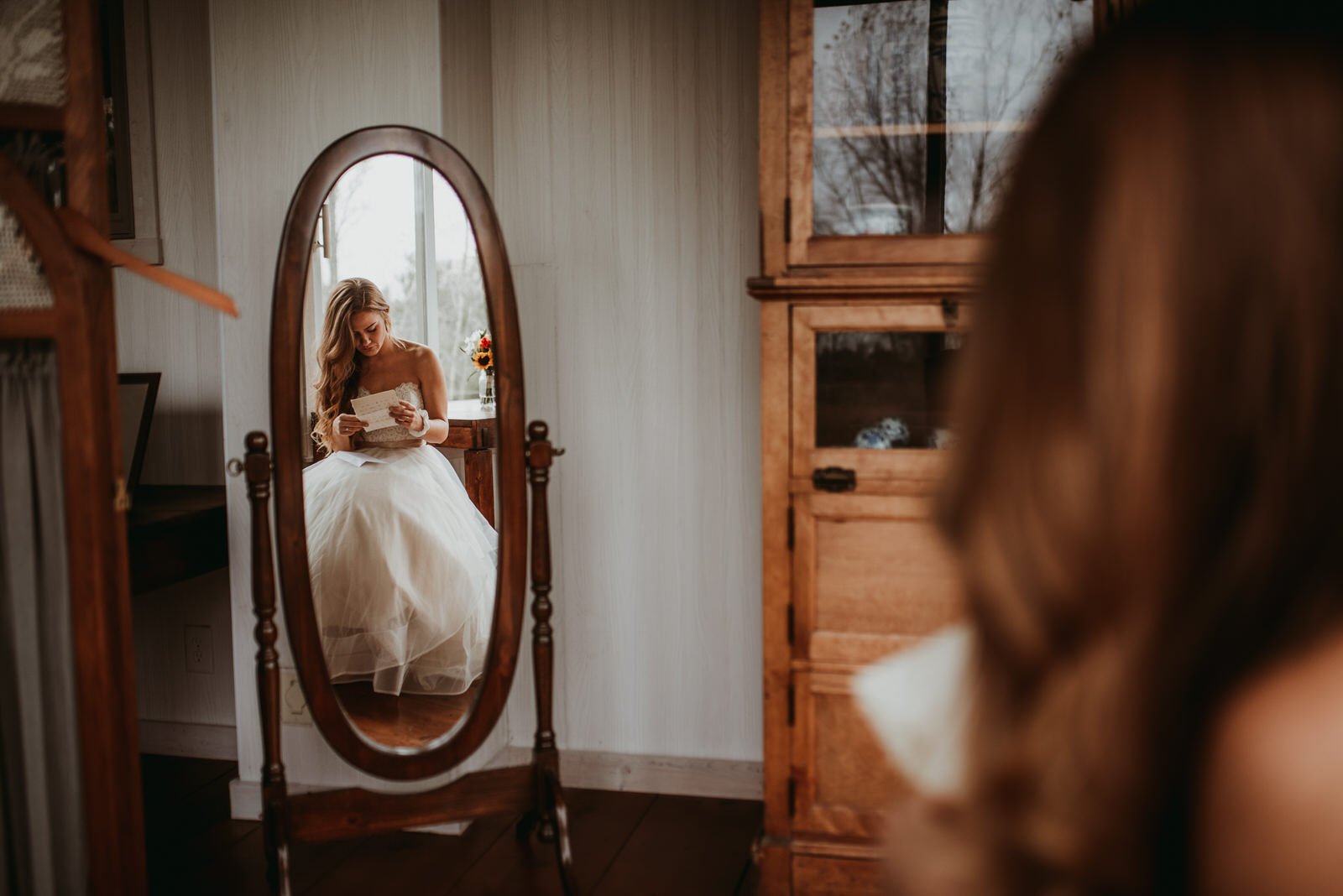 BHLDN dress, bride in front of a mirror, moody photography, Chicago wedding photography - The Adamkovi