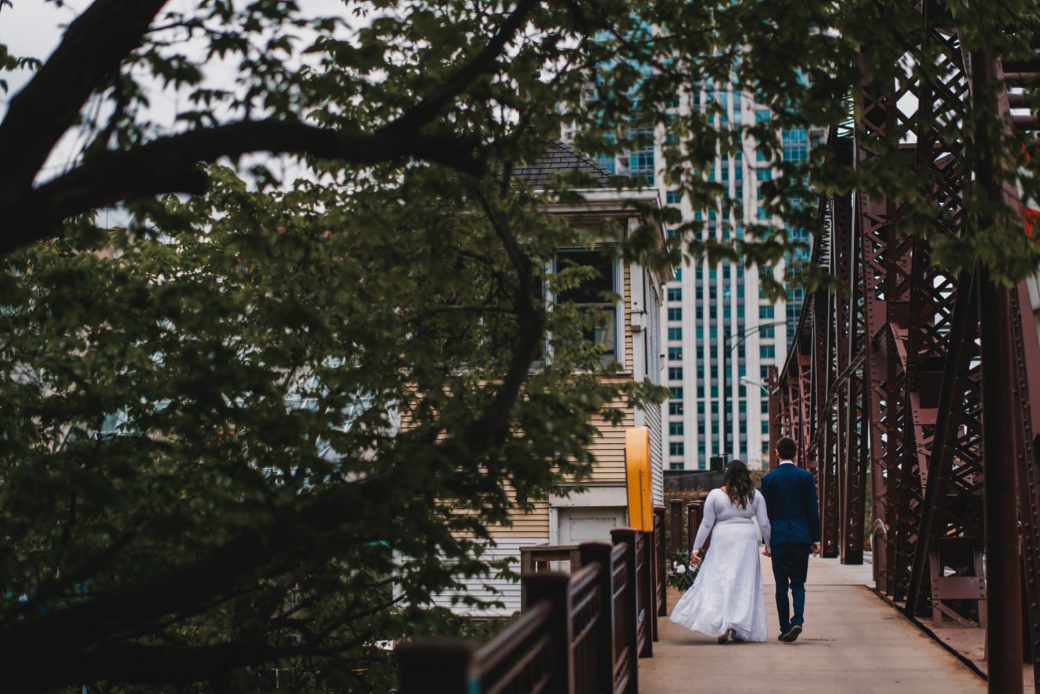 Chicago Elopement photographer - The Adamkovi, bride and groom walking on a kinzie street bridge