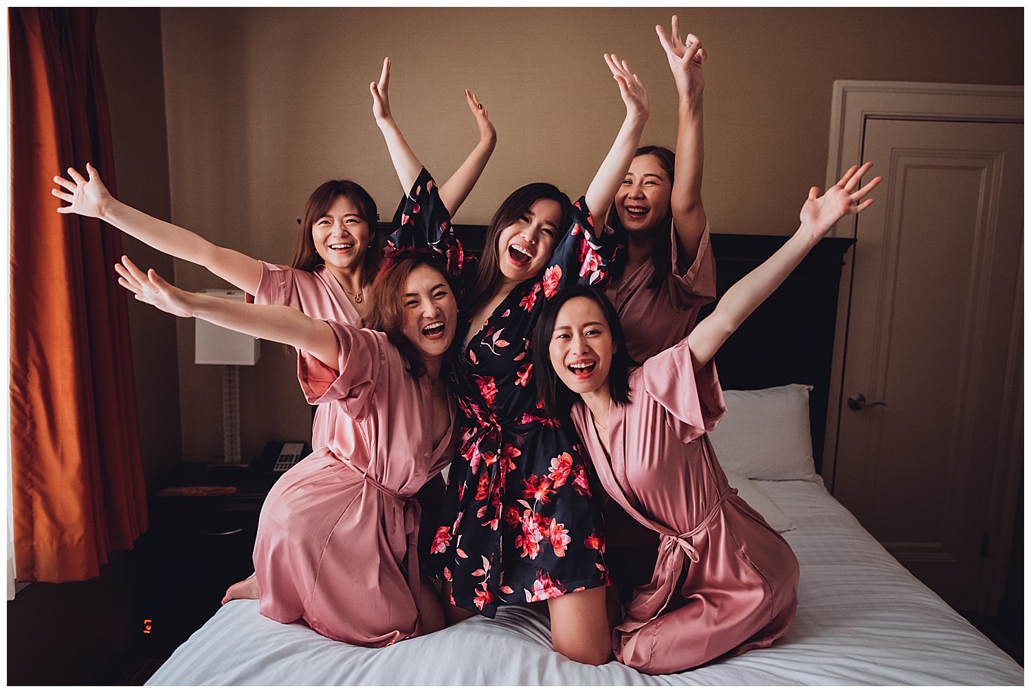 The carleton of Oak Park Wedding getting ready, bride and bridesmaids photo on a bed