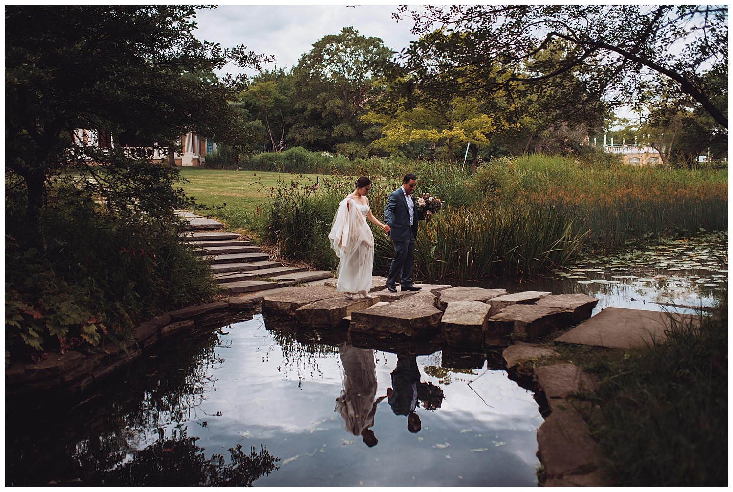 Columbus Park Refectory Wedding, bride and groom walking over a pond