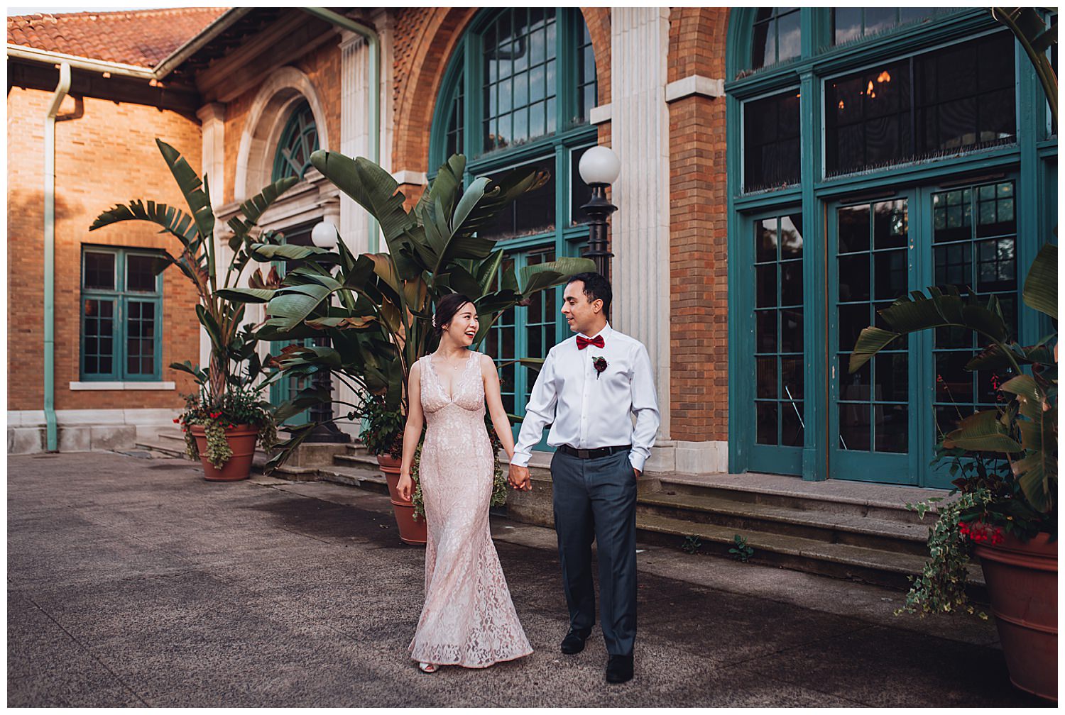 Columbus Park Refectory Wedding, bride and groom walking with palm trees behind them