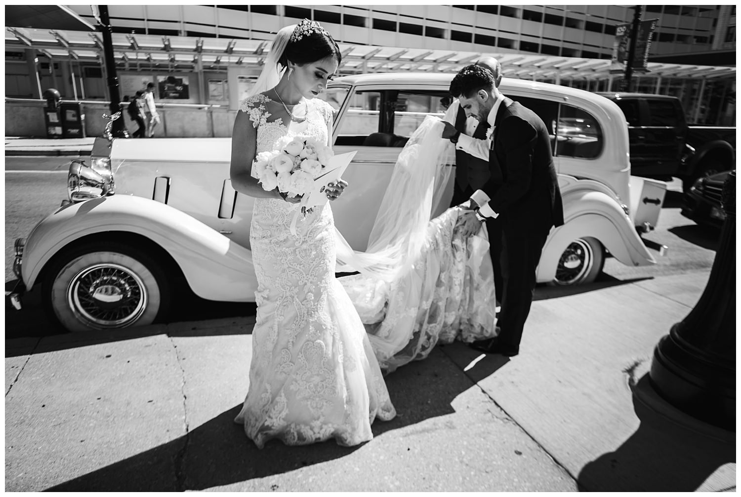 bride and groom in a rolls royce
