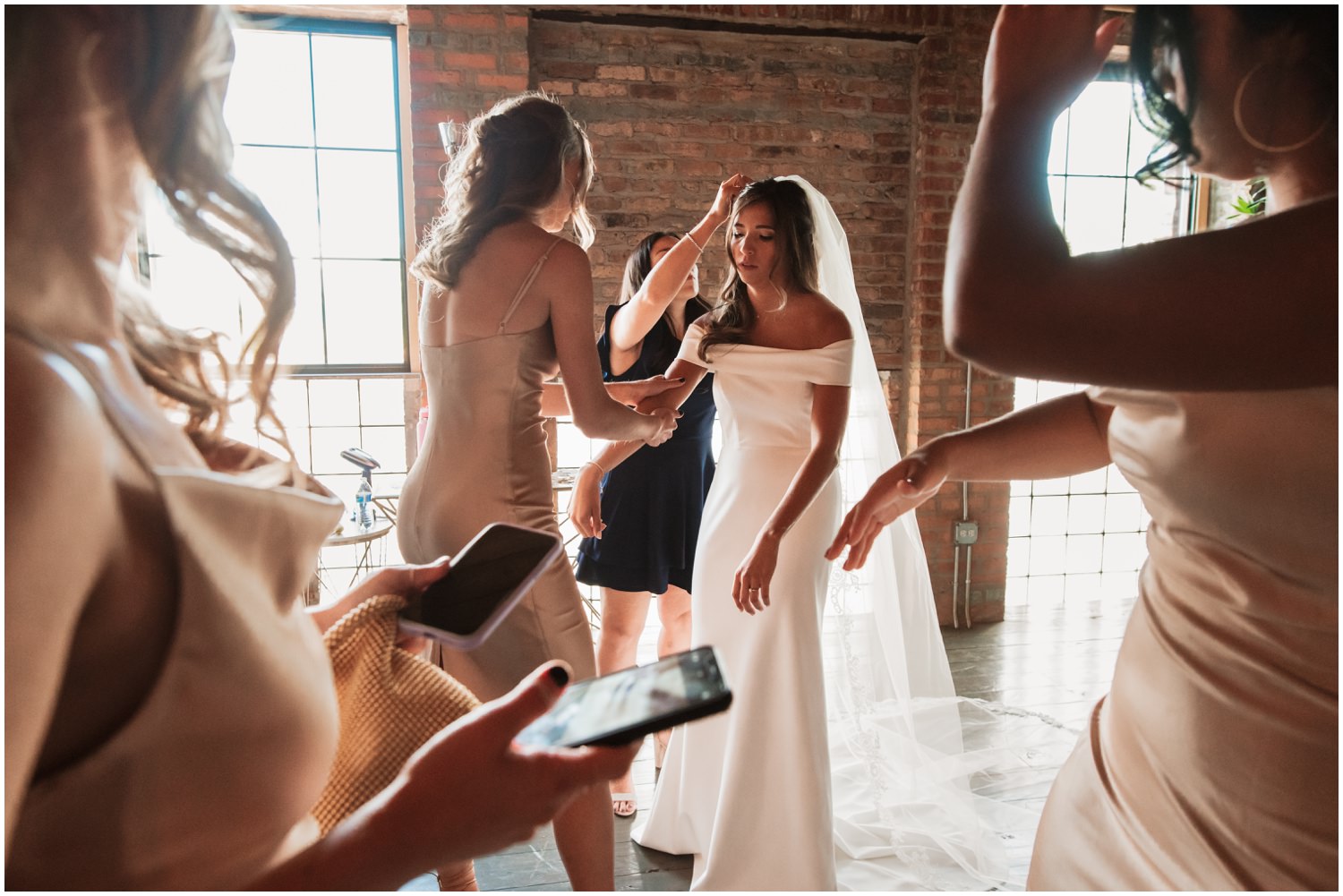 Fairlie Chicago Wedding getting ready bridesmaids helping bride to get ready
