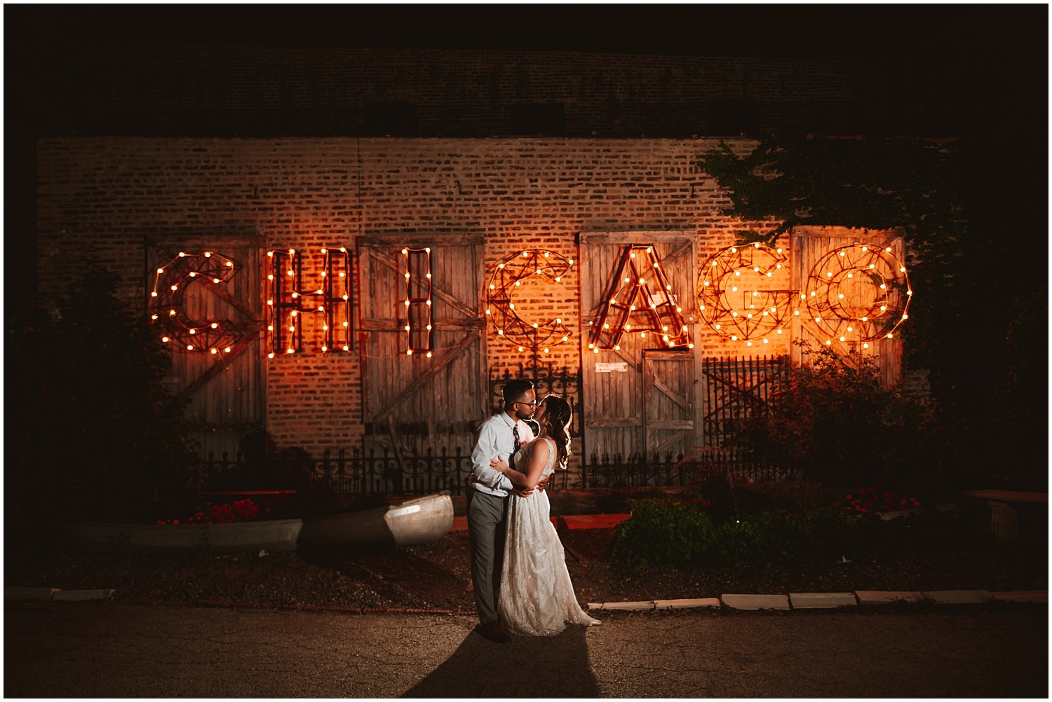 Salvage One documentary Wedding Photography - Night Chicago sign with bride and groom portrait